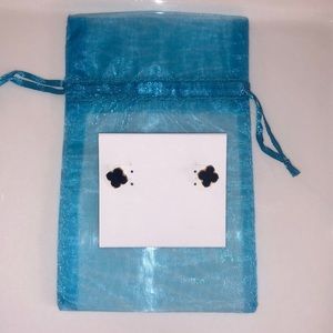 Black with gold colored trim pierced earrings. Sold with blue jewelry bag.